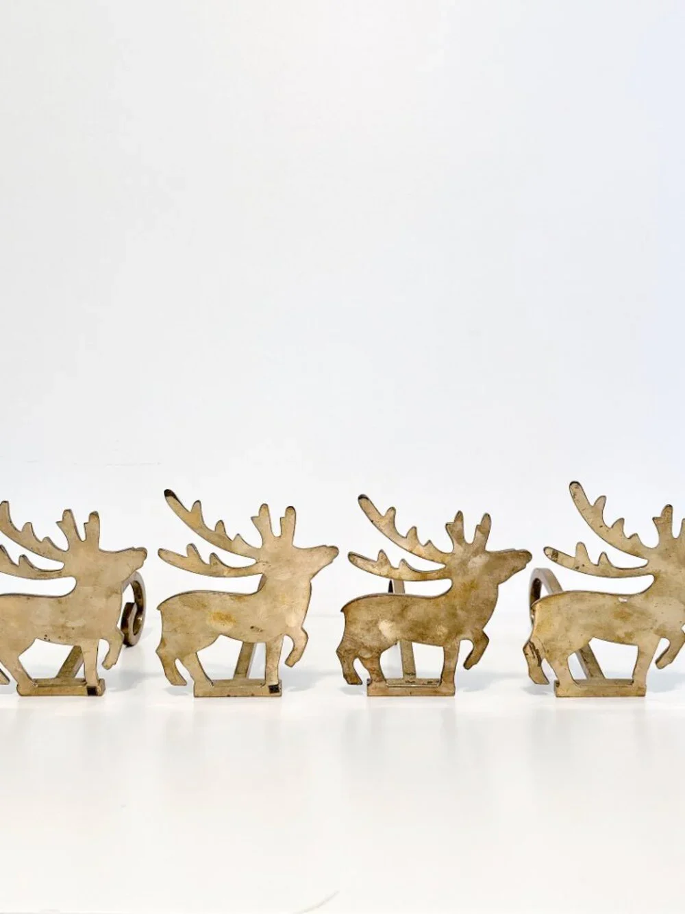 SET OF FOUR BRASS REINDEER MANTEL STOCKING HANGERS